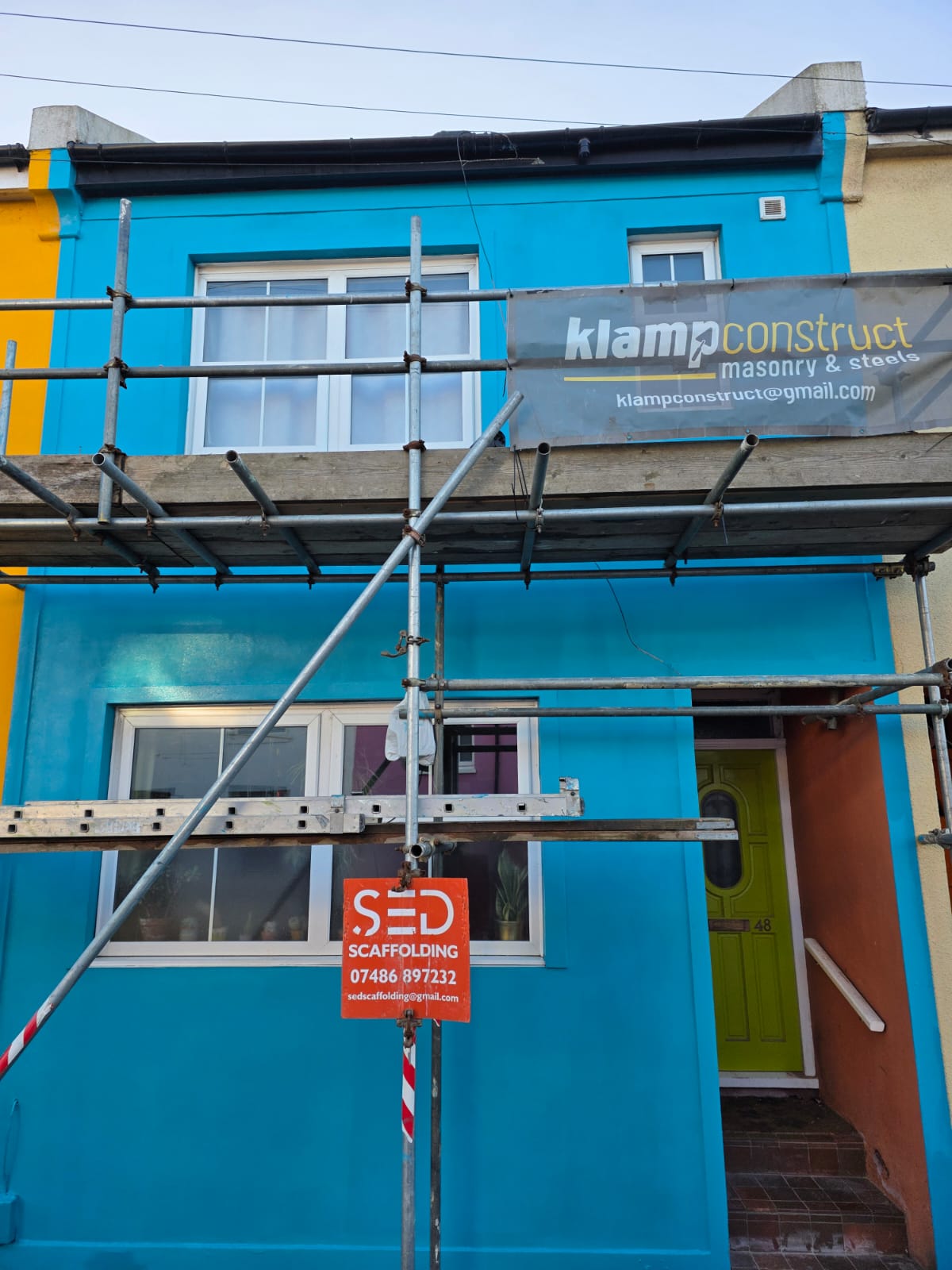 Rendered terraced house, scaffolded