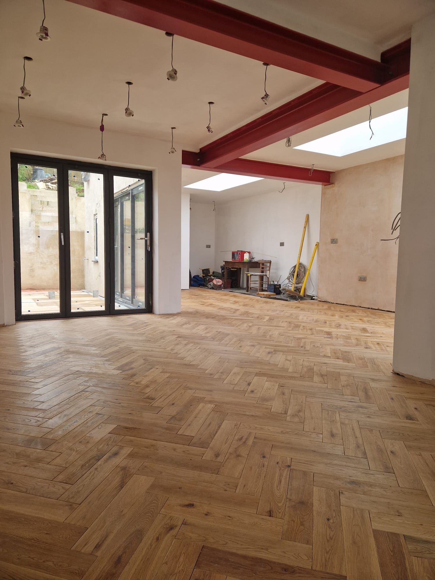 Steel beams over a herringbone floor