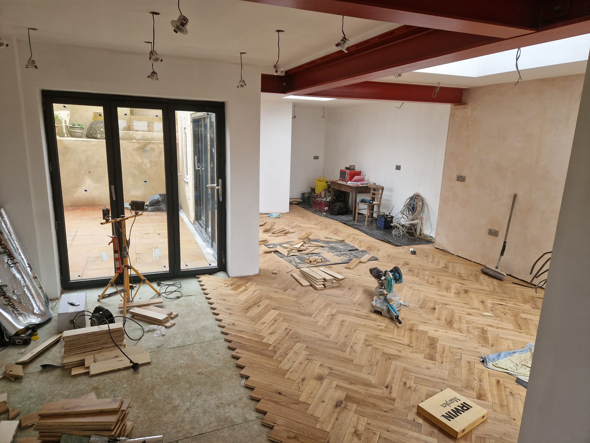 Herringbone parquet mid-installation