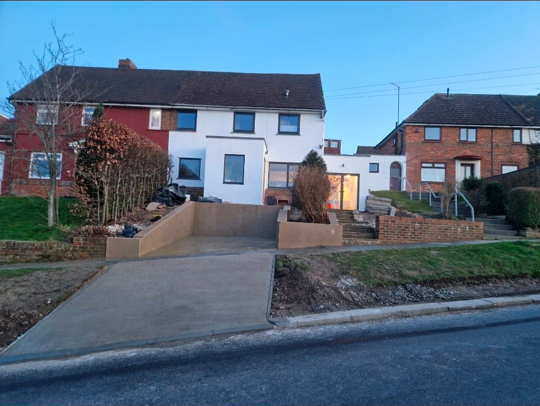 Freshly rendered house exterior with new driveway ramp